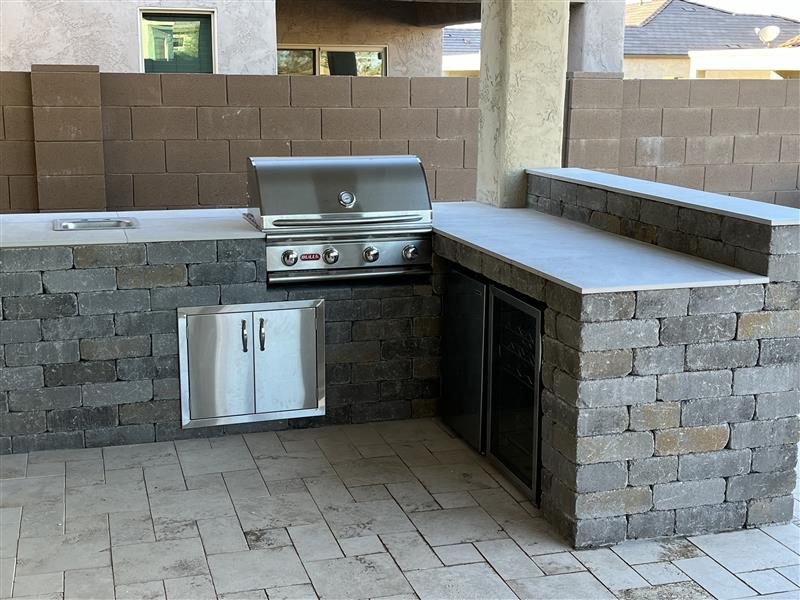 Outdoor kitchen built with pavers and stone